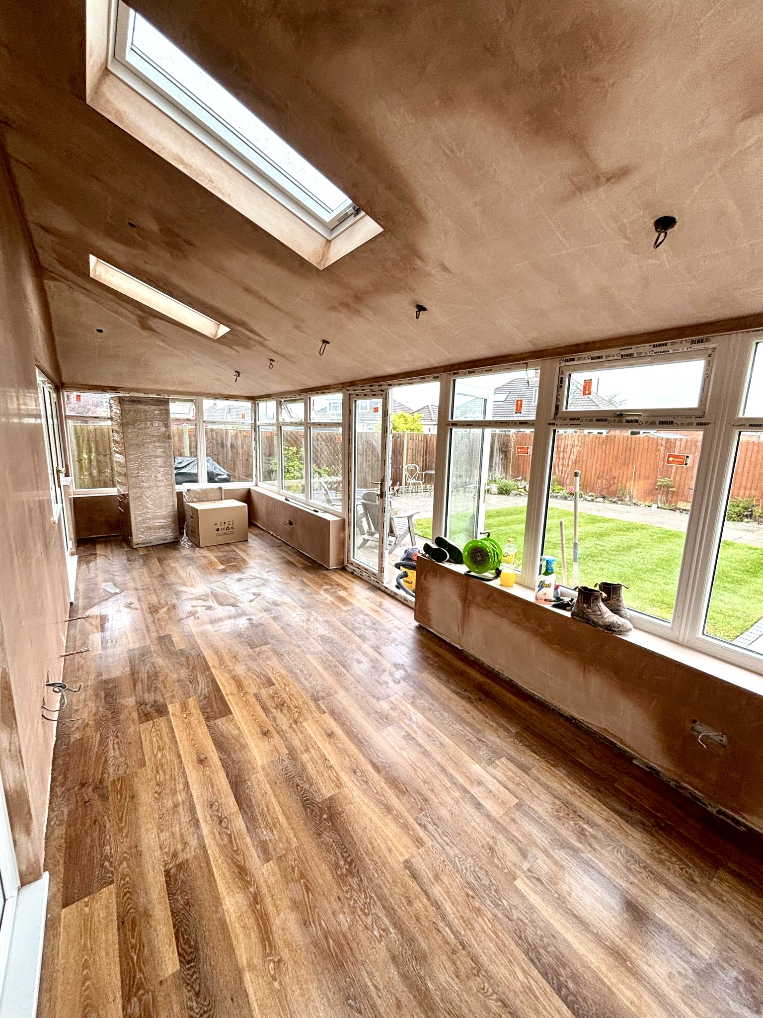 A garden room with a skimmed sloping ceiling and rooflights